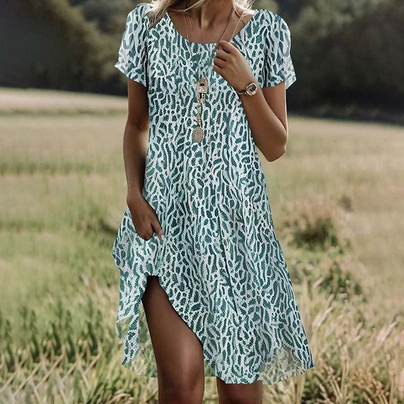 "Elegantes Vintage Damenkleid mit floralem Muster und Knopfleiste, taillierter Schnitt, Retro Mode für besondere Anlässe."